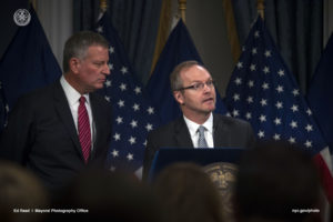 Mayor De Blasio and DOB Commissioner Chander at Bill signing.